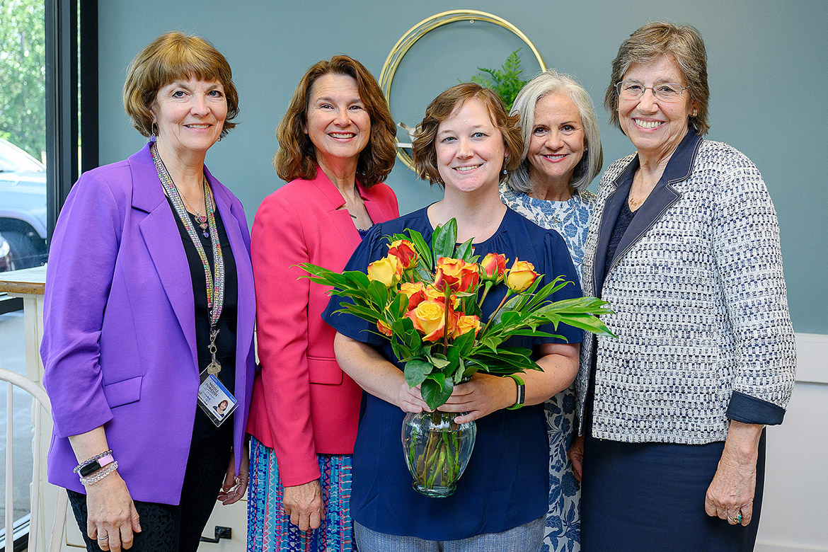 Maigan Wipfli, holding a bouquet, with the First-Year and Nontraditional Student Engagement in the Center for Student Involvement and Leadership at Middle Tennessee State University in Murfreesboro, Tenn., was given the Outstanding Mentor for Women award by the June S. Anderson Foundation during a luncheon held Aug. 15, 2025, to present this year’s winners of the June S. Anderson Scholarship. Pictured, from left, are Andrienne Friedli, MTSU chemistry professor and current president of the foundation; Ginger Rowell, MTSU math professor and foundation member; Wipfli; Theresa Cole, first JSA Foundation scholarship winner; and Margaret Behm, the foundation’s lawyer. (MTSU photo by Andy Heidt)
