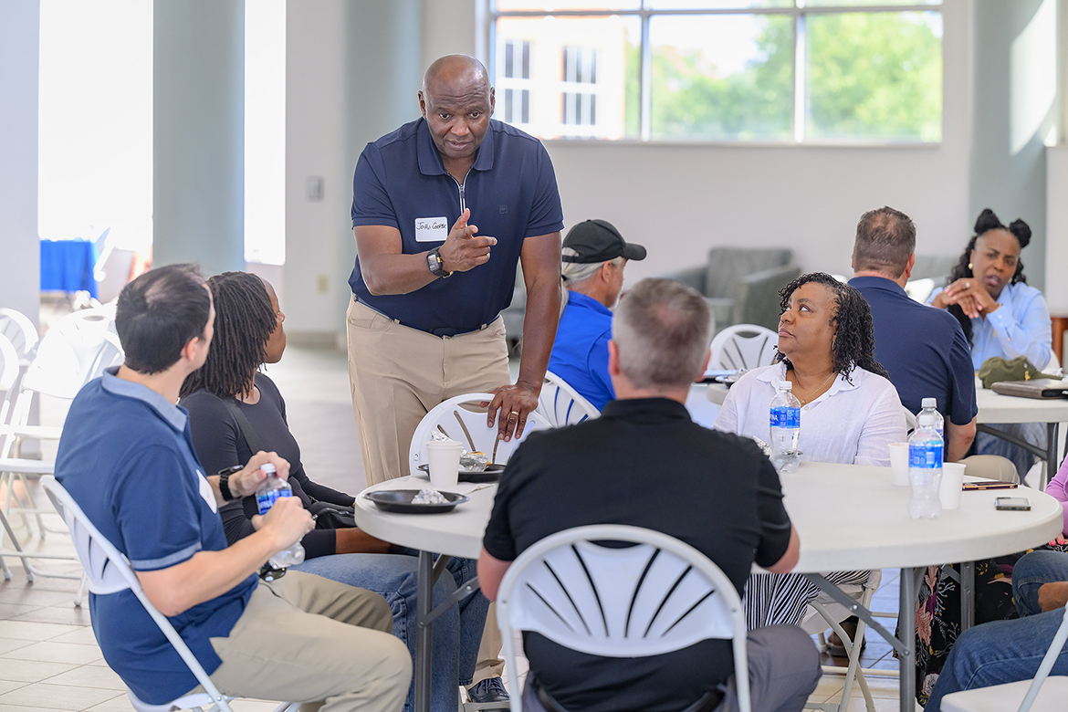 John Cooper, a U.S. Army veteran and Nashville International Airport executive vice president, visits with airport employees attending a veterans’ benefits fair hosted by the Middle Tennessee State University Charlie and Hazel Daniels Veterans and Military Family Center in mid-August in the Miller Education Center on Bell Street in Murfreesboro, Tenn. (MTSU photo by J. Intintoli)