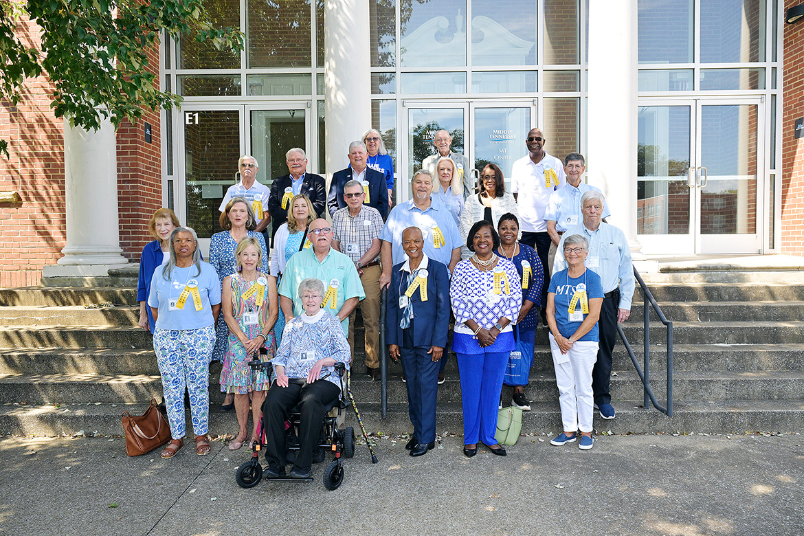 Golden Raiders from the Class of 1975 and prior years gather for a group photo outside the Middle Tennessee State University Sam Ingram Building on Middle Tennessee Boulevard in Murfreesboro, Tenn., on Friday, Sept. 19. The group toured campus, enjoyed lunch and reminisced about past years on campus. (MTSU photo by Andy Heidt)