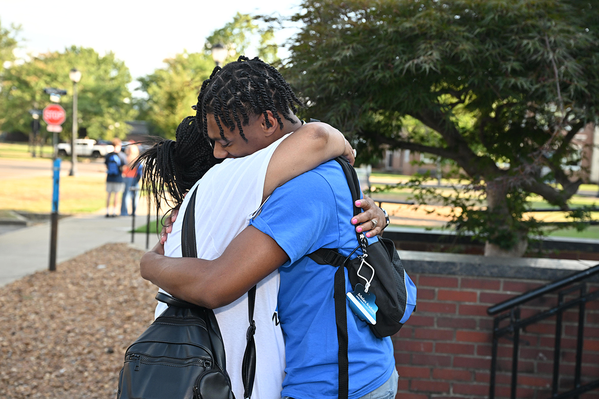 Outside Tucker Theatre on the Middle Tennessee State University campus in Murfreesboro, Tenn., on Aug. 10, a mother and son share a hug before she heads home and he embarks on a two-week Scholars Academy program to better acclimate him and other students to the campus environment before the start of the fall semester. Nearly 150 participants attended Scholars Academy this summer. (MTSU photo by James Cessna)