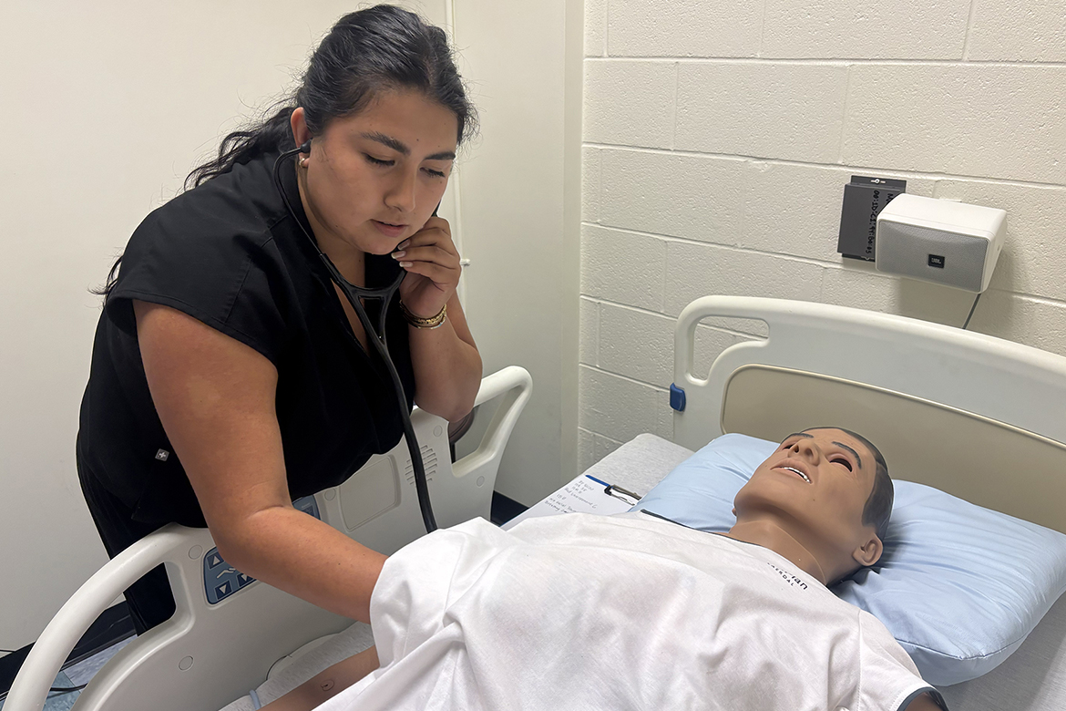 Viviana Bocanegra, a first-year Physician Assistant Studies student at Middle Tennessee State University in Murfreesboro, Tenn., examines a patient in a mock mass casualty simulation held in July inside the Cason-Kennedy Nursing Building on campus. The high-fidelity mannequin simulated a patient injured during a tornado as part of the hands-on test training. (MTSU photo by Nancy DeGennaro)