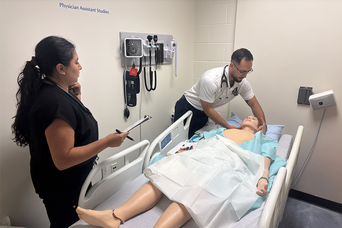 Viviana Bocanegra, left, and Jesse Scobee, first-year Physician Assistant Studies students at Middle Tennessee State University in Murfreesboro, Tenn., examine a “patient” during a mock mass casualty simulation held in July. The high-fidelity patient mannequin simulates a real-world situation to give students hands-on training before starting a year of clinical rotations in the second year of the 27-month program. (MTSU photo by Nancy DeGennaro)