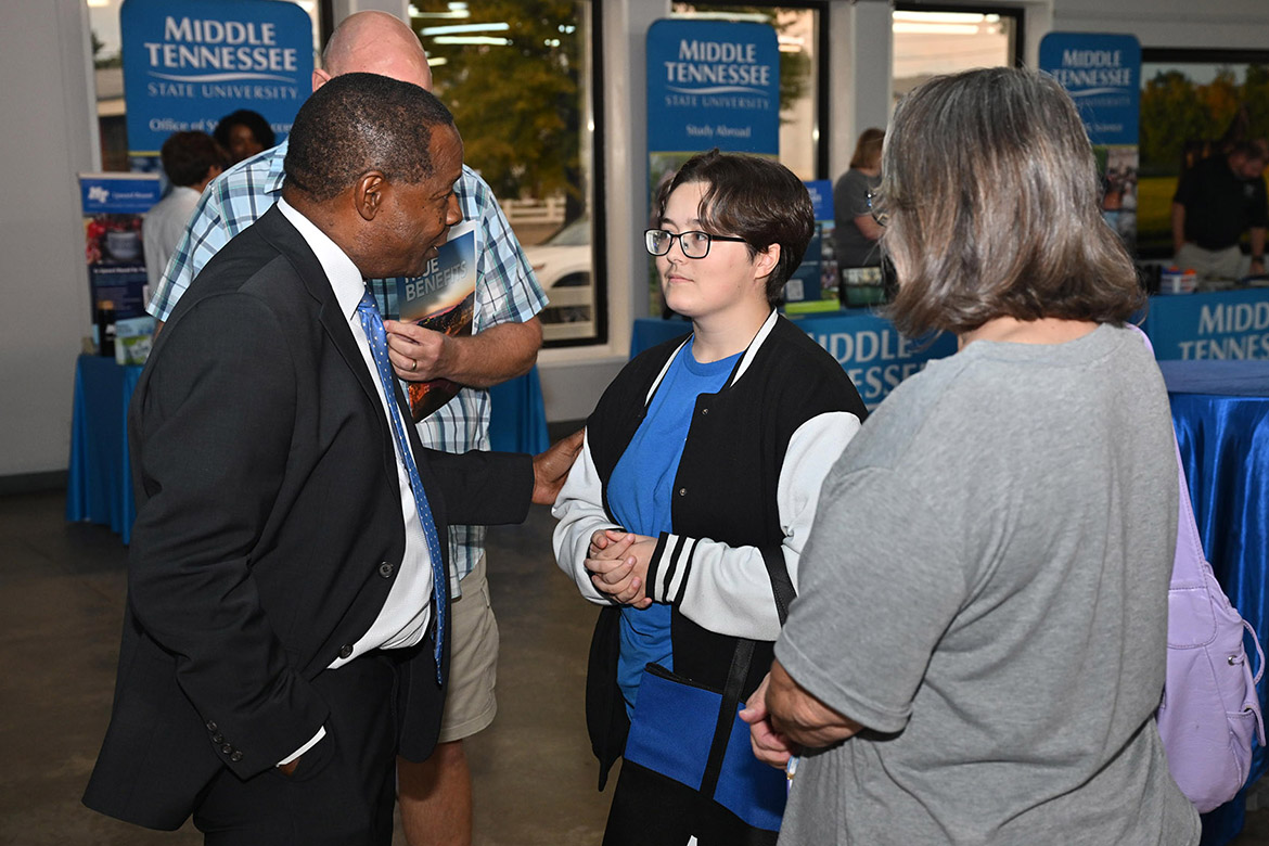 Middle Tennessee State University President Sidney A. McPhee, left, talks with Trin Fleet, a senior at Forrest School in Chapel Hill, Tenn., and her mother, Patty Fleet, about the opportunities available at MTSU during the 2025 True Blue Tour kickoff student reception held Tuesday night, Sept. 16, at the Blue Ribbon Circle Club in Shelbyville, Tenn. The 17-year-old plans to attend MTSU to major in theater. (MTSU photo by James Cessna)