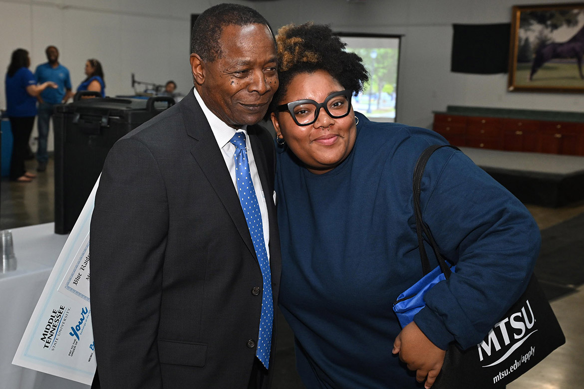 Middle Tennessee State University President Sidney A. McPhee, left, hugs a very happy scholarship winner Marriana Hendon of Tullahoma, Tenn., during the 2025 True Blue Tour kickoff student reception held Tuesday night, Sept. 16, at the Blue Ribbon Circle Club in Shelbyville, Tenn. Hendon, who plans a career in social work, is currently enrolled at Motlow State Community College but plans to transfer next year. (MTSU photo by James Cessna)