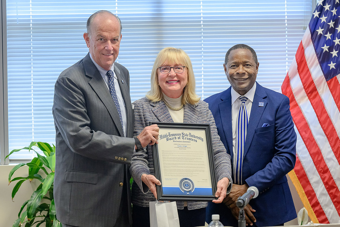 Pam Wright, center, outgoing member of the Middle Tennessee State University Board of Trustees, accepts a framed copy of the resolution honoring her service on the board from Board Chairman Stephen Smith, left, and MTSU President Sidney A. McPhee at the start of the board’s fall quarterly meeting on Tuesday, Sept. 9, at the Miller Education Center in Murfreesboro, Tenn. (MTSU photo by J. Intintoli)
