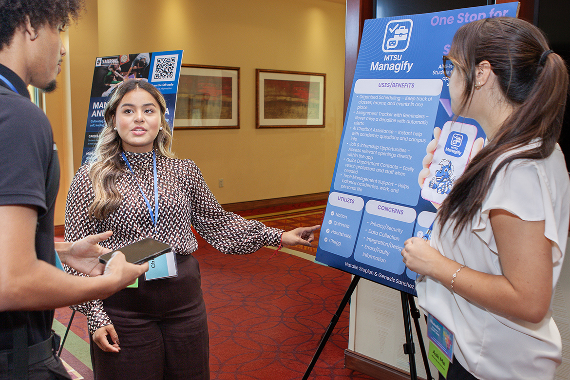 Genesis Sanchez, center left, a management and leadership major at Middle Tennessee State University, explains the app concept developed by her and teammate and human resources major Natalie Stepien, right, to another student attending MTSU’s 2025 Jones College of Business Leadership Summit on Sept. 26 at Embassy Suites in Murfreesboro, Tenn. Sanchez and Stepien were awarded Best Concept and a $200 stipend in the summit’s Innovative Leadership Challenge for the proposed app called MTSU Managify that would serve as a one-stop shop for management students on campus. (MTSU photo by Tom Beckwith)