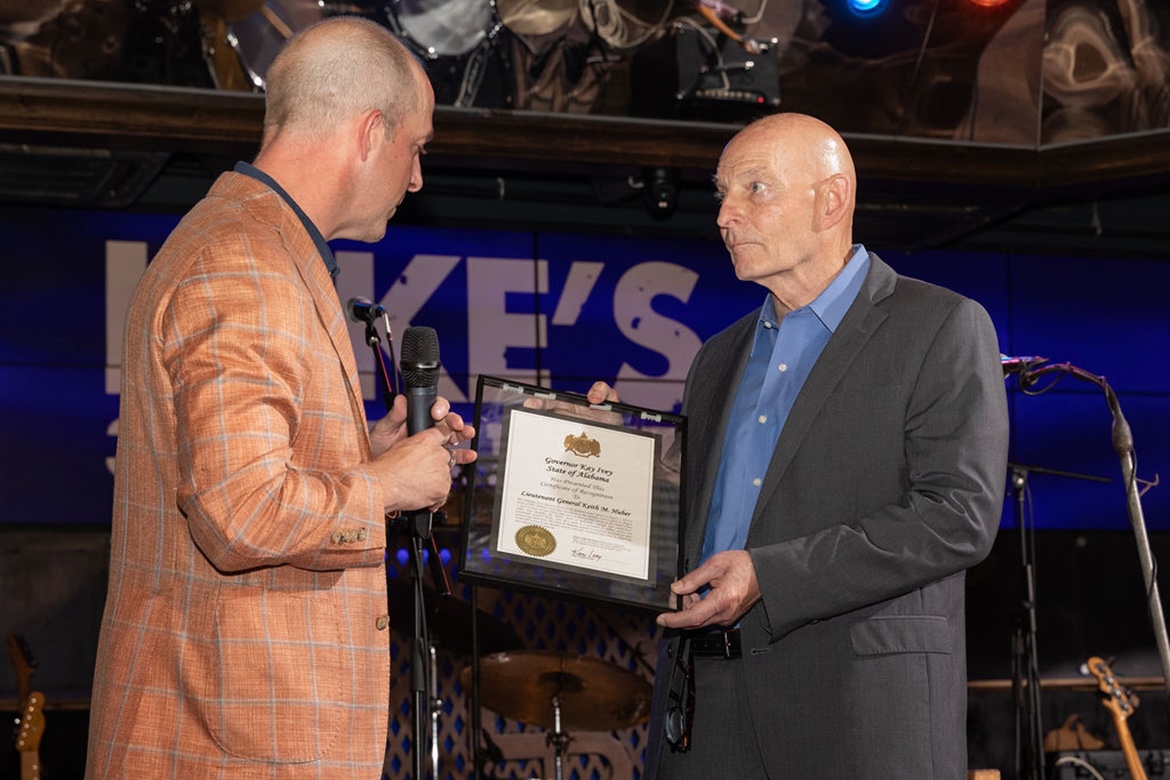 On behalf of Alabama Gov. Kay Ivey, Brandon Dillard, left, Alabama Power senior vice president of resource strategy and stakeholder engagement, presents a certification of recognition and commendation to Keith M. Huber, Middle Tennessee State University senior adviser for veterans and leadership initiatives and retired U.S. Army lieutenant general, earlier this summer in Nashville, Tenn. The certificate of recognition said Huber “exemplifies the highest ideals of leadership, courage and commitment. … Your life’s work is a testament to selfless service and unwavering dedication.” (Photo by Bass Photography)