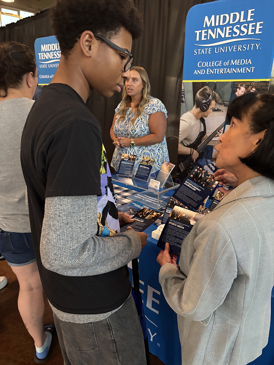 Zeny Sarabia-Panol, right, associate dean in the Scott Borchetta College of Media and Entertainment at Middle Tennessee State University, tells Santana Small, 16, a West Creek High School junior about the variety of programs her college offers during the Thursday, Oct. 2, True Blue Tour stop in Clarksville, Tenn., at the Wilma Rudolph Event Center. (MTSU photo by Randy Weiler)