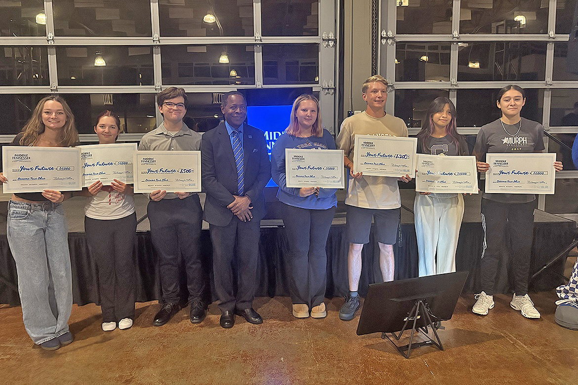 Middle Tennessee State University President Sidney A. McPhee, fourth from left, stands with seven Clarksville-area high school students whose names were drawn for scholarships Thursday, Oct. 2, during the MTSU True Blue Tour stop in Clarksville, Tenn., at the Wilma Rudolph Event Center. (MTSU photo by Randy Weiler)