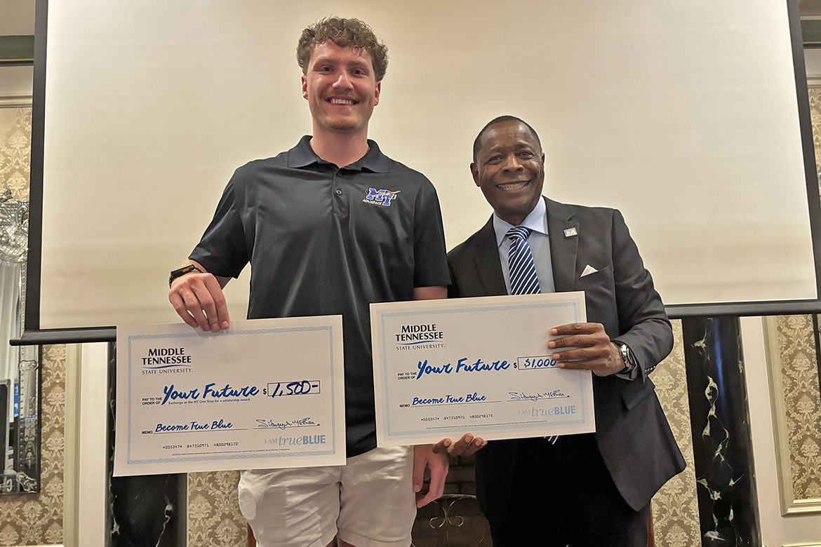 Pictured with Middle Tennessee State University President Sidney A. McPhee, right, Elias Orchard, of Gray, Tenn., who plans to pursue a professional pilot degree from MTSU’s Department of Aerospace, received scholarships totaling $2,500 during the university’s annual True Blue Tour recruiting stop at The Carnegie Hotel in Johnson City on Wednesday, Oct. 15. (MTSU photo by Randy Weiler)