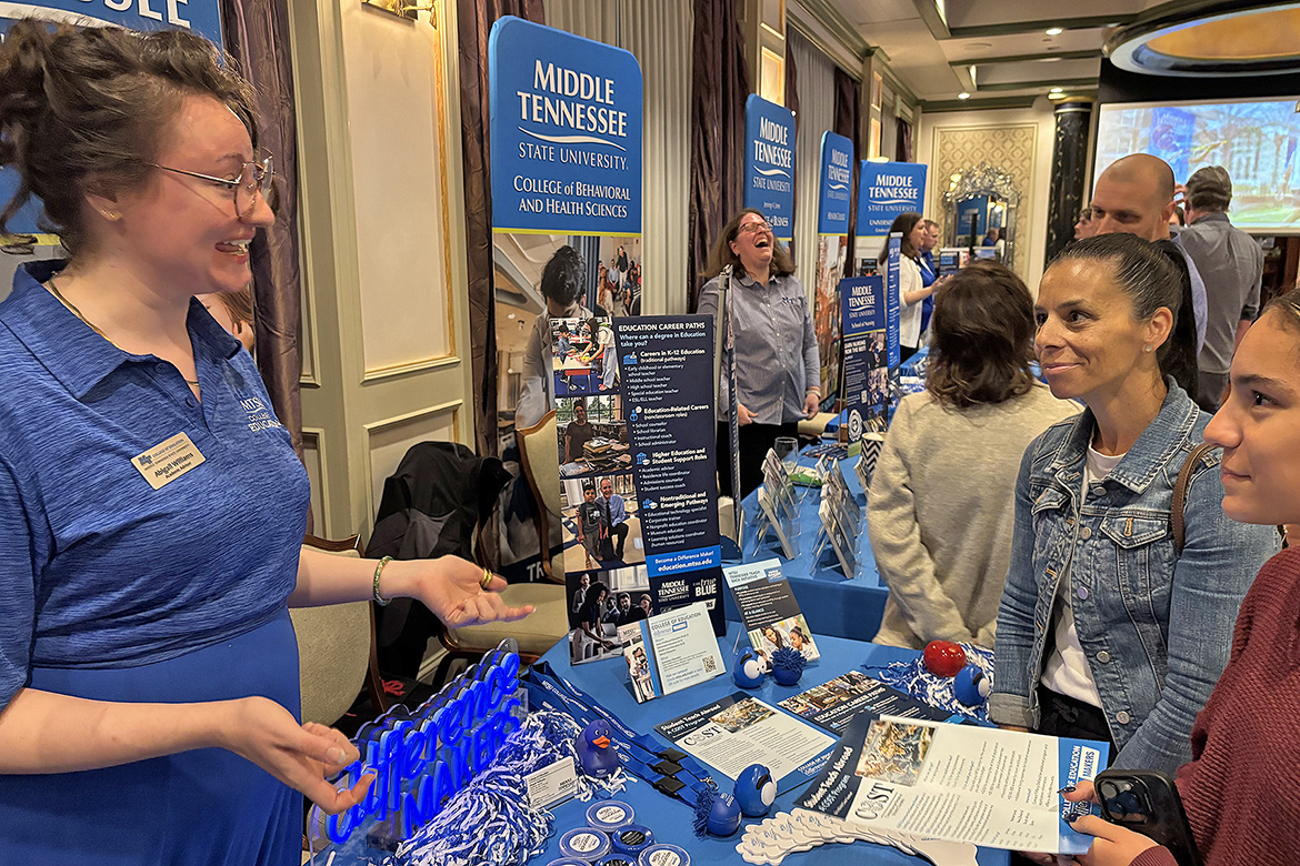 Abigail Williams, left, Middle Tennessee State University academic advisor for the College of Education, discusses opportunities to student teach abroad with Nicole Piazza, center, and her daughter, Savannah Piazza, of Jonesborough, Tenn., on Wednesday, Oct. 15, at the MTSU True Blue Tour recruiting event at The Carnegie Hotel in Johnson City. Savannah Piazza is a junior at David Crockett High School in Jonesborough. (MTSU photo by Randy Weiler)