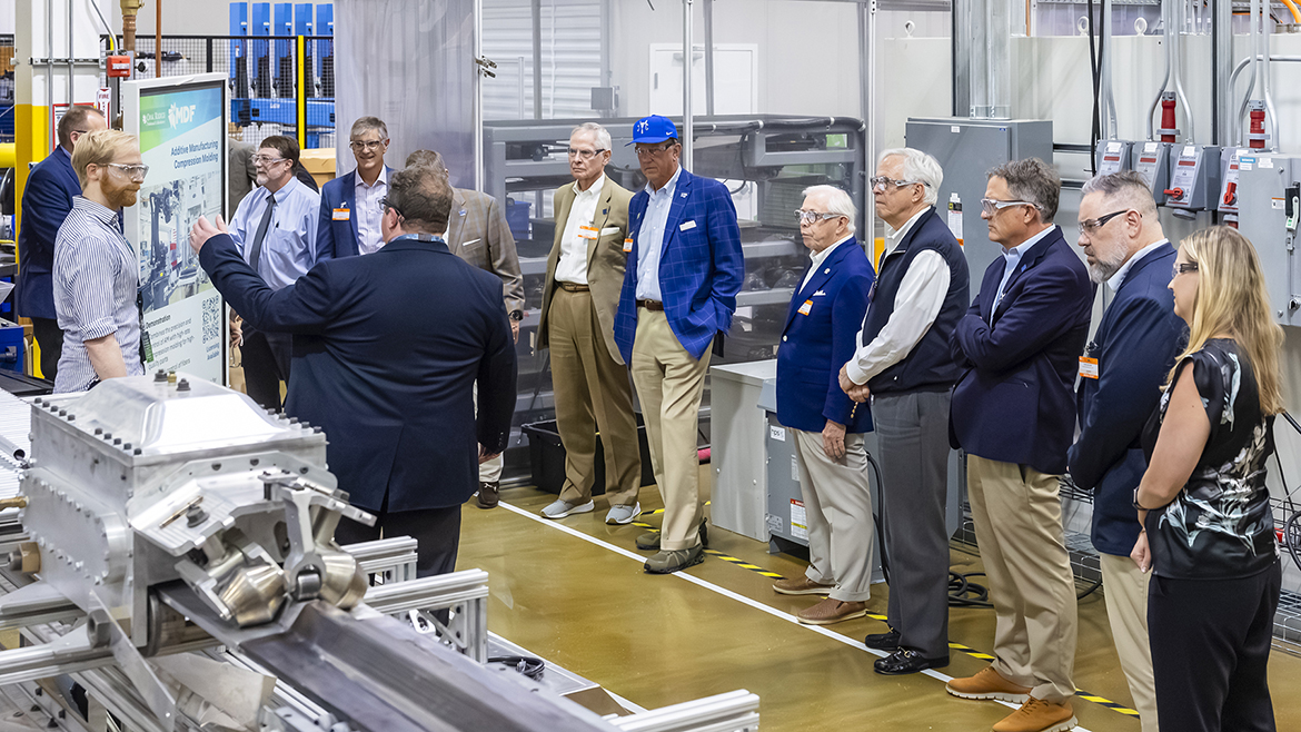 Middle Tennessee State University administrators, faculty and Board of Trustees members learn about continuous additive manufacturing compression molding during a tour stop at Oak Ridge National Laboratory in Oak Ridge, Tenn., this summer. (Oak Ridge National Laboratory photo)