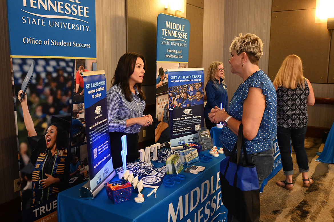 Monique Ward, left, assistant director of the Scholars Academy in the Office of Student Success at Middle Tennessee State University in Murfreesboro, Tenn., shares information with College of Education alumnus Michelle Sheivle, a guidance counselor at Coffee County Central High School in East Tennessee, at the university’s True Blue Tour recruitment stop Sept. 25 at The Chattanoogan Hotel in Chattanooga, Tenn. (MTSU photo by Jimmy Hart)
