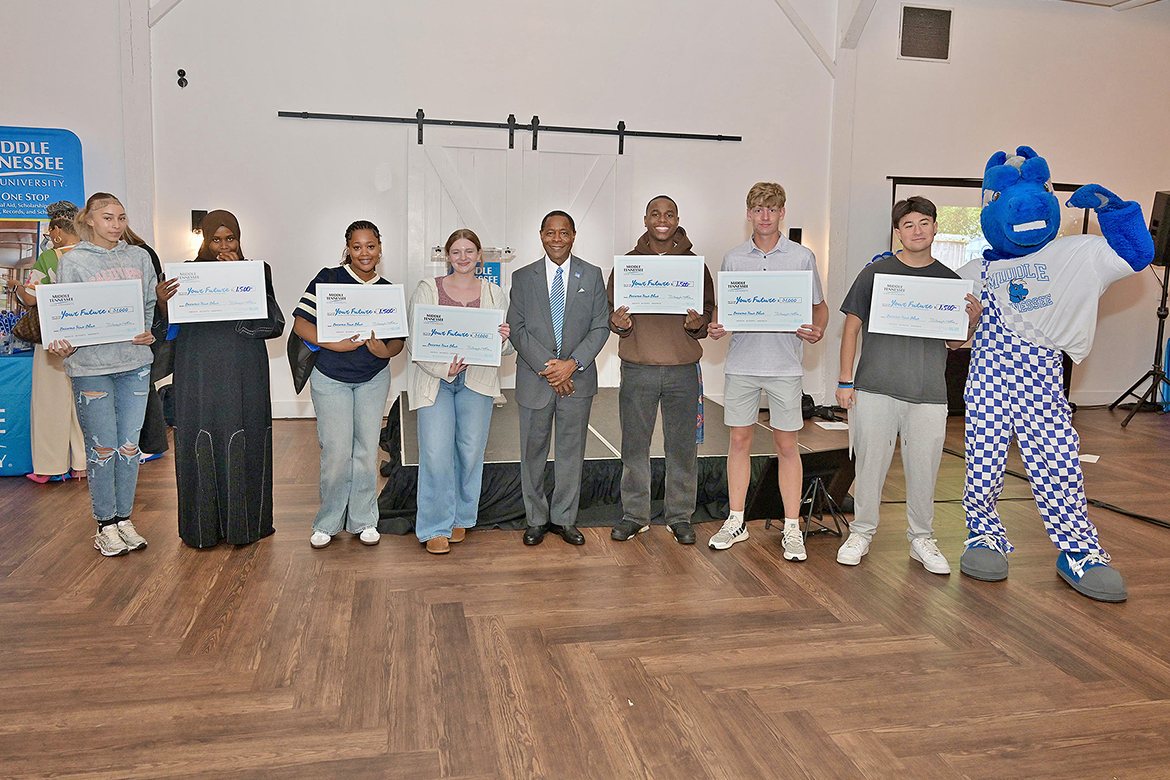 Middle Tennessee State University President Sidney A. McPhee, center, stands with students who were among the lucky winners in the scholarship drawings at the True Blue Tour recruitment stop for prospective students held Monday, Sept. 29, at 14TENN event center in Nashville, Tenn. Seven students won a total of $9,000 in scholarships. (MTSU photo by James Cessna)