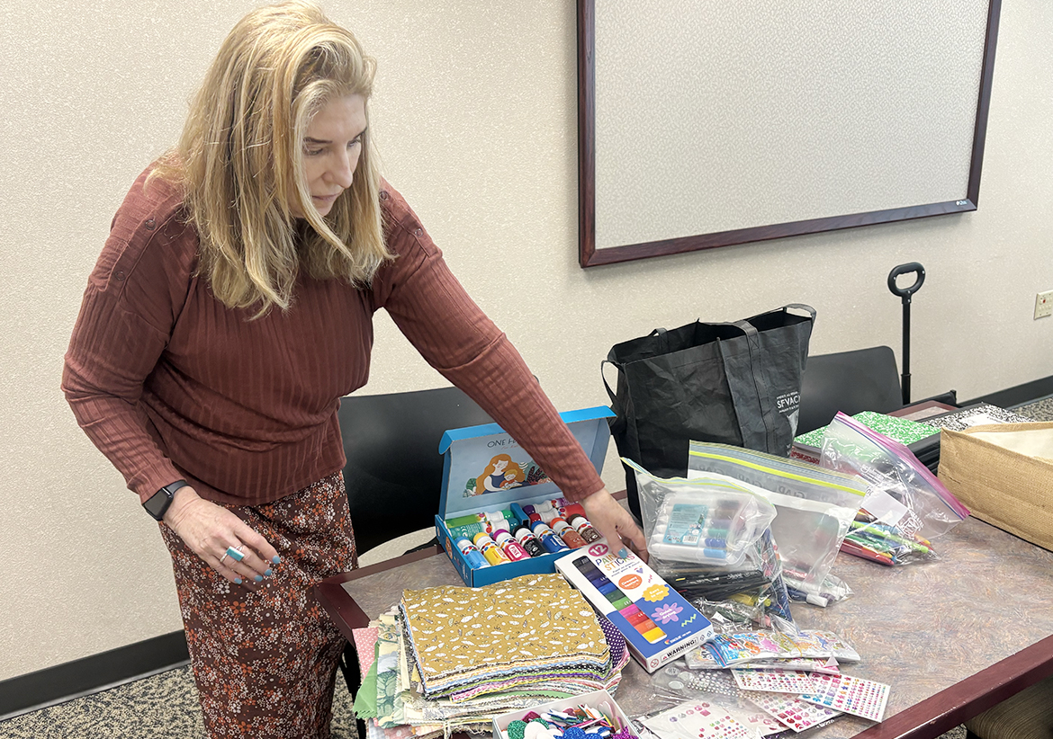 Hillorie McLarty, a doctoral student at Middle Tennessee State University in Murfreesboro, Tenn., sorts through craft supplies as part of an exercise in the “Tacos and Trauma” writing workshops she established through the University Writing Center, where she is a graduate assistant. During the weekly workshops, McLarty plays music and then prompts the participants in a free-writing session based on a weekly topic. (MTSU photo by Nancy DeGennaro)