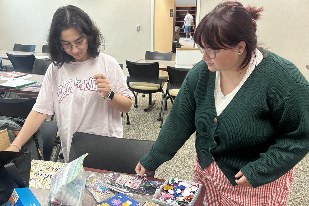 Middle Tennessee State University students Gamze Mert, left, and Chelsea Barranger sort through craft supplies as part of the “Tacos and Trauma” workshop held at 1 p.m. each Friday through Nov. 20 at James E. Walker Library on campus in Murfreesboro, Tenn. The free weekly workshop sessions are meant to improve writing skills as well as help with mental wellness through the brain’s ability to change through positive, repetitive actions — including writing and crafting. (MTSU photo by Nancy DeGennaro)