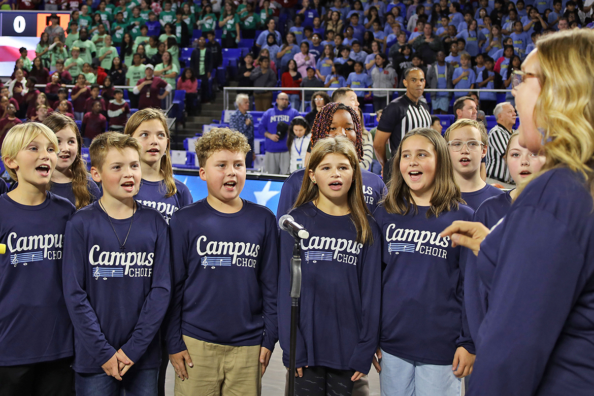 Students from Middle Tennessee State University’s partner school, Homer Pittard Campus School, sing the national anthem, led by teacher Stacy Ray, before the start of the Blue Raider men’s basketball game with the Milligan Buffaloes for the annual Rutherford County Schools Education Day held Wednesday, Nov. 5, in Murphy Center on campus in Murfreesboro, Tenn. (Photo courtesy Rutherford County Schools)