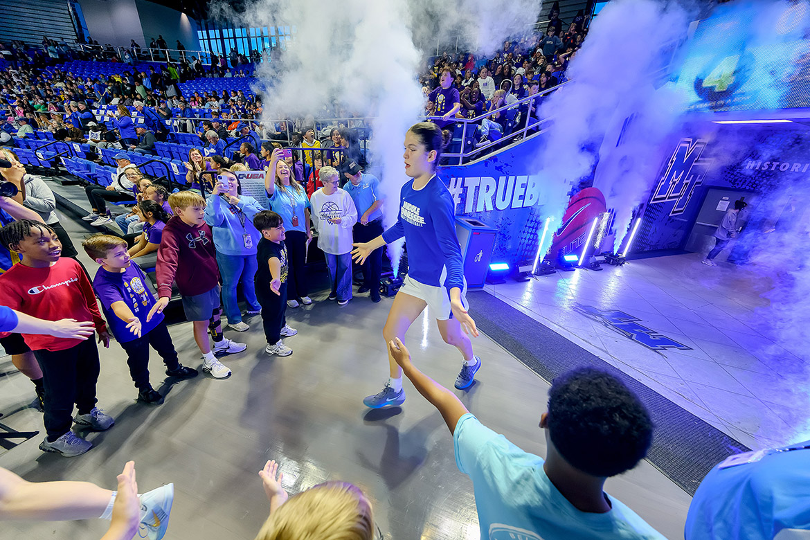 Middle Tennessee State University Lady Raiders receive high-fives as they enter the court in Murphy Center on campus in Murfreesboro, Tenn., before the start of the annual Education Day game held Monday, Nov. 3. More than 4,500 fourth- through sixth-grade students from 14 city schools attended the annual event. (MTSU photo by Andy Heidt)