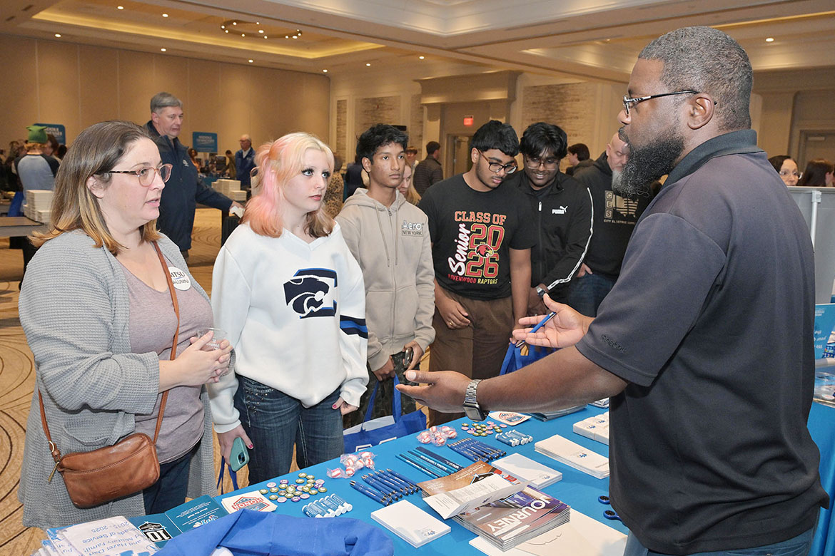 Chris Rochelle, assistant director of the Charlie and Hazel Daniels Veterans and Military Family Center at Middle Tennessee State University in Murfreesboro, Tenn., talks with students and a parent at MTSU’s final True Blue Tour stop recruitment event held Thursday, Nov. 13, at Franklin Marriott Cool Springs. (MTSU photo by James Cessna)