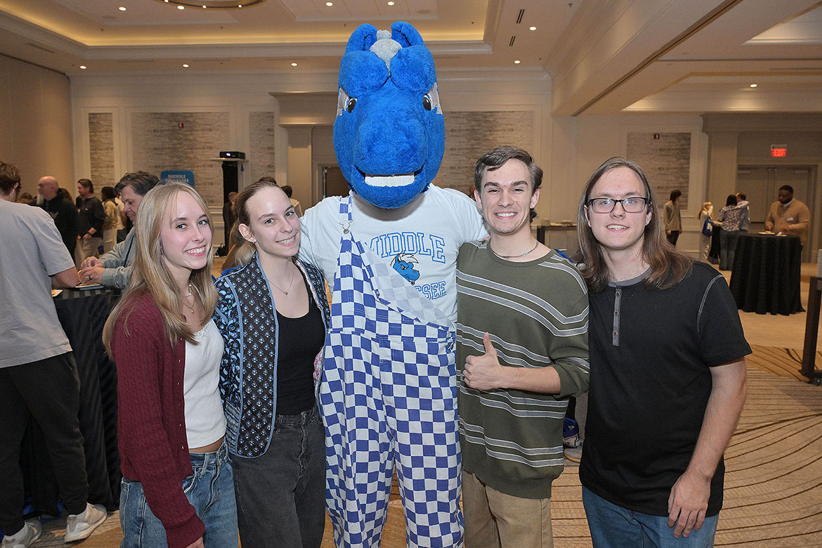 Middle Tennessee State University mascot Lightning, center, stands with the Peveto quadruplets from Franklin, Tenn., during MTSU’s final True Blue Tour stop student recruitment event held Thursday, Nov. 13, at Franklin Marriott Cool Springs. From left, Lainey, Avery, Cooper and Tanner Peveto plan to attend MTSU in Murfreesboro, Tenn., together and all four were awarded scholarships at the evening event. (MTSU photo by James Cessna)