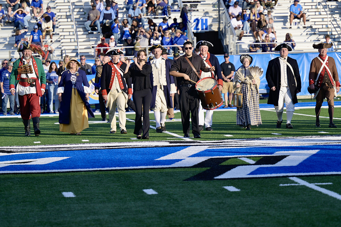 Band of Blue fife and drum musicians lead participants in colonial soldier costumes and Daughters of the American Revolution members across Horace Jones Field on Saturday, Nov. 8, during halftime ceremonies for the 43rd annual Salute to Veterans and Armed Forces game in Floyd Stadium on campus in Murfreesboro, Tenn. (MTSU photo by Cat Curtis Murphy)