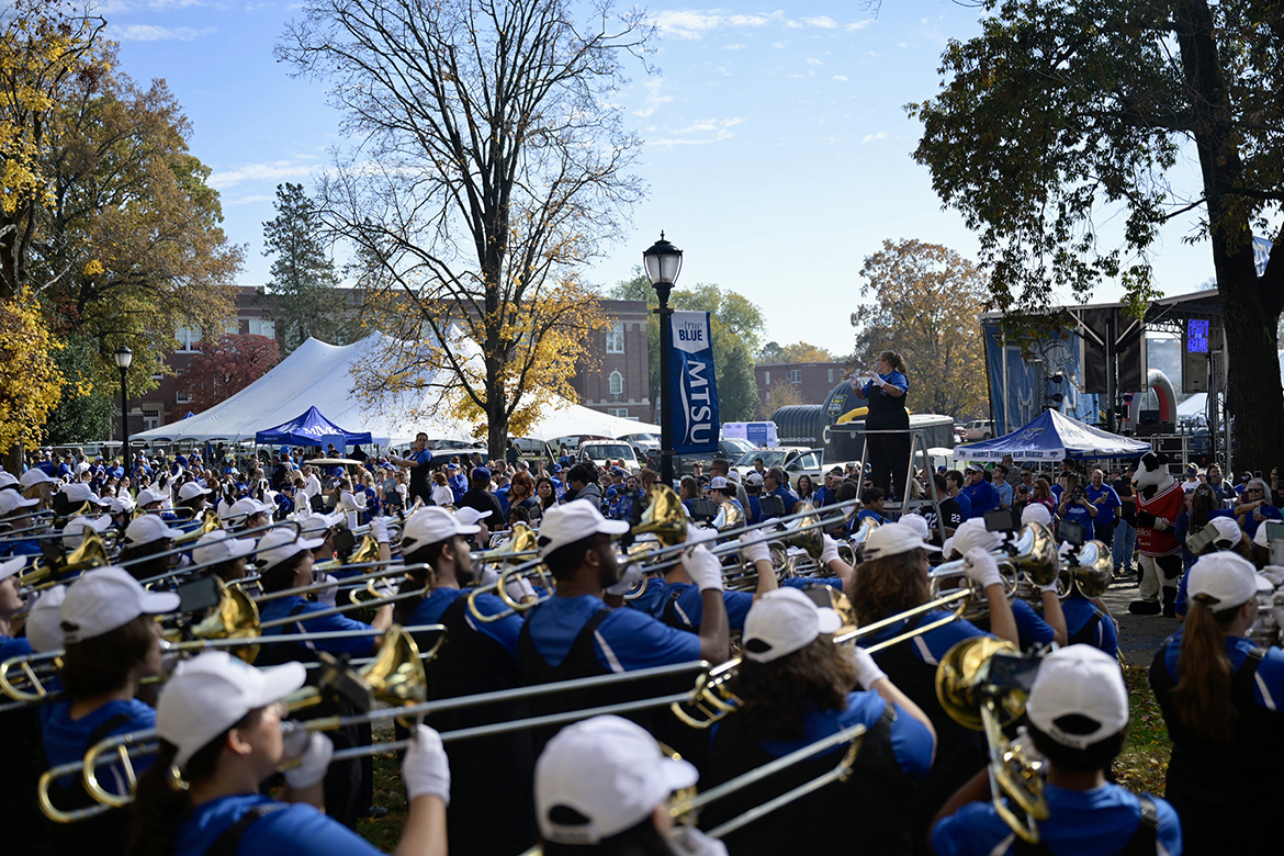 Surrounded by a crowd of fans attending the pregame Party in the Grove, the Middle Tennessee State University Band of Blue performs a song leading up to the “Raider Walk” by Blue Raider football team members on Saturday, Nov. 8, in Walnut Grove on campus in Murfreesboro, Tenn. (MTSU photo by Cat Curtis Murphy)