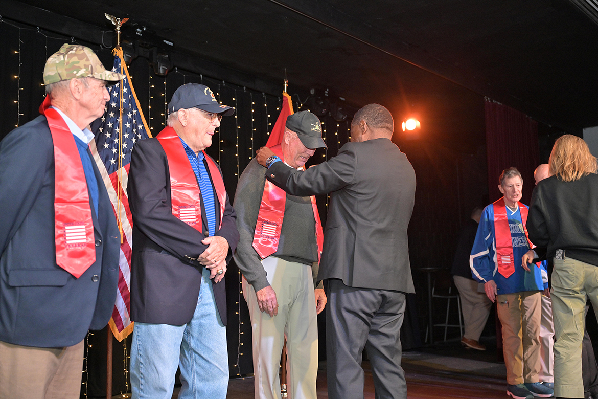 Middle Tennessee State University President Sidney A. McPhee, center right, adjusts the red stole presented to veteran Jeff Davidson, a former Rutherford County mayor and U.S. Army veteran, during a special stole presentation hosted by MTSU’s Daniels Veterans Center in the Keathley University Theater on campus in Murfreesboro, Tenn., on Saturday, Nov. 8. Judge Ben Hall McFarlin, left, Don Witherspoon, Bud Morris, far right, and Andy Womack, not pictured, also received stoles. (MTSU photo by Cat Curtis Murphy)