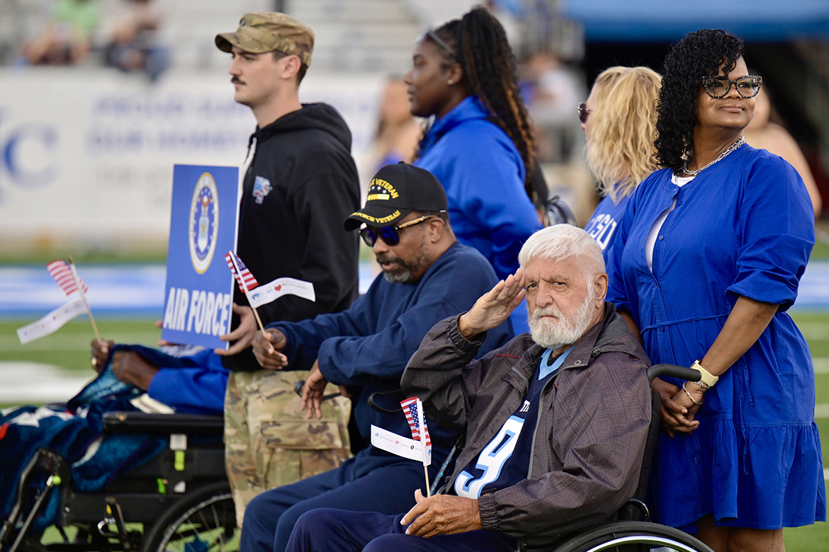 With assistance, U.S. Air Force veterans wait their turn to go across Horace Jones Field during the special halftime tribute by the Band of Blue performing military branch theme songs on Saturday, Nov. 8, in Floyd Stadium on campus in Murfreesboro, Tenn., as part of the university’s 43rd Salute to Veterans and Armed Forces game. (MTSU photo by Cat Curtis Murphy)