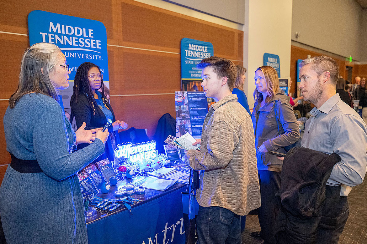 Tiffany Fantine, director of advising in the College of Education at Middle Tennessee State University in Murfreesboro, Tenn., talks with a student and his parents at the True Blue Tour evening reception for prospective Blue Raiders held Tuesday, Nov. 11, in the Student Union Ballroom on campus. (MTSU photo by Cat Curtis Murphy)
