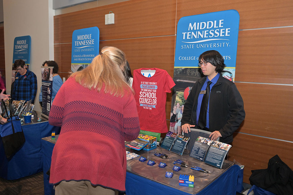 Don Srisuriyo, advisor for the Middle Tennessee State University College of Liberal Arts in Murfreesboro, Tenn., talks with a counselor at the True Blue Tour luncheon held for school counselors and community college advisors on Tuesday, Nov. 11, on campus in the Student Union Building. (MTSU photo by James Cessna)