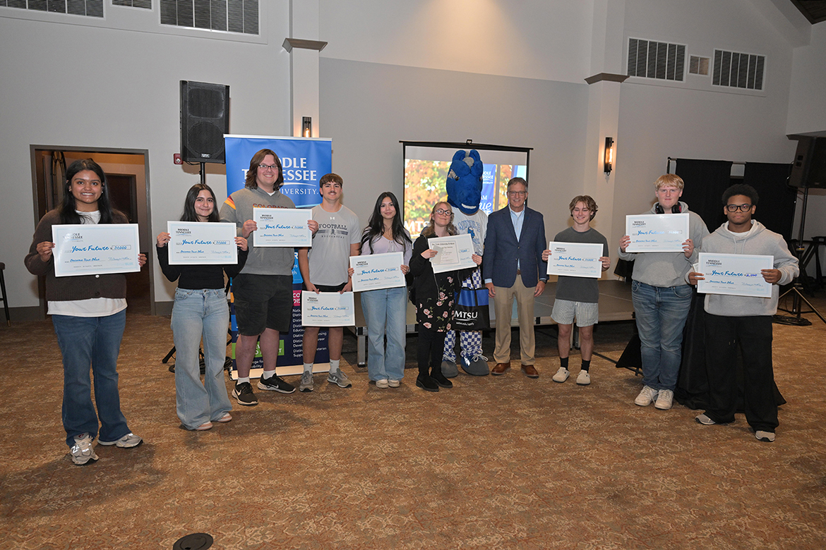 Shown with Provost Mark Byrnes, fourth from right, and mascot Lightning, students from Sumner County high schools and Volunteer State Community College were elated to receive scholarships from Middle Tennessee State University near the close of the first True Blue Tour event in Gallatin, Tenn., at Grasslands Country Club on Thursday, Oct. 23. (MTSU photo by James Cessna)