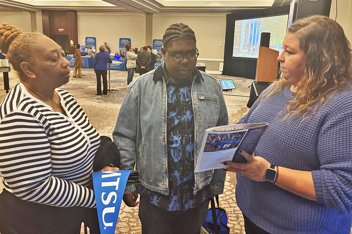 Becca Smitty, right, Middle Tennessee State University MT One Stop director, provides information and answers questions for a prospective student and his mother attending the MTSU True Blue Tour recruiting event recently at the Westin Hotel in Huntsville, Ala. (MTSU photo by Randy Weiler)