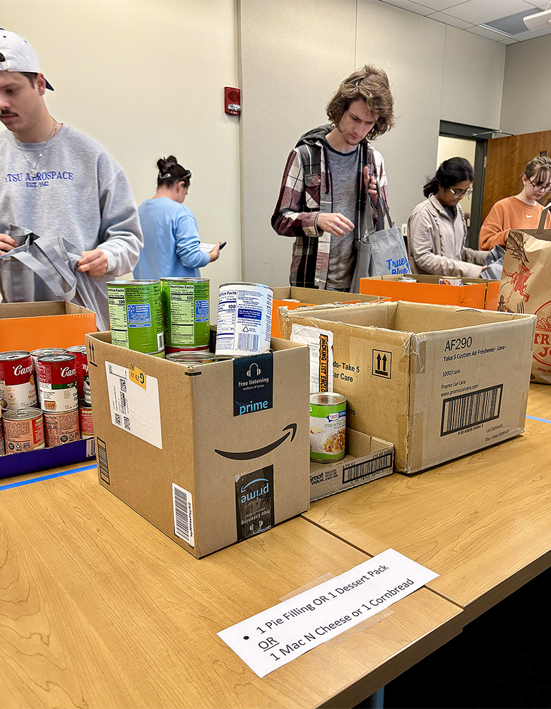 Students from the University Honors College Research Seminar class at Middle Tennessee State University in Murfreesboro, Tenn., assemble nonperishable items for Thanksgiving meal bags for students in need inside the Student Union on Wednesday, Nov. 5, in the Center for Student Involvement and Leadership at the Student Union Building on campus. (MTSU photo by Nancy DeGennaro)