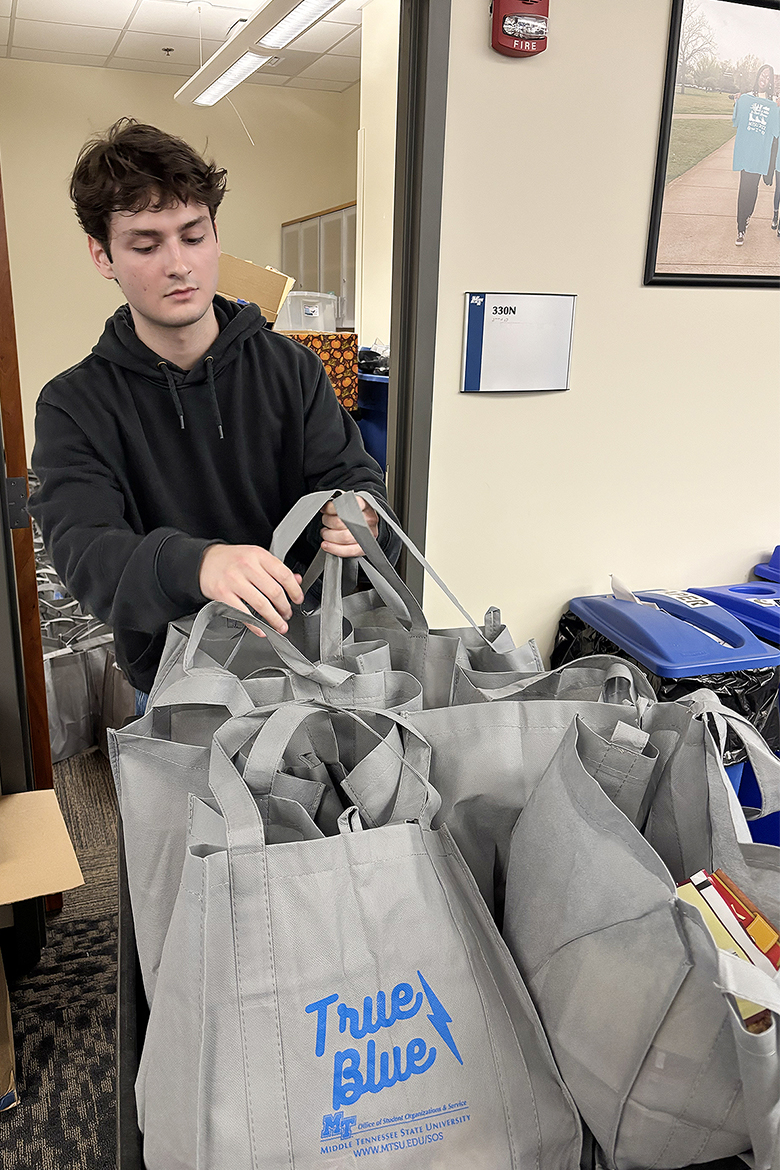 A student in the Honors College at Middle Tennessee State University in Murfreesboro, Tenn., sorts Thanksgiving meal bags that will benefit students in need on campus this holiday season. Student volunteers collected and assembled a total of 109 Thanksgiving meal bags inside the Student Union that were distributed Thursday, Nov. 6, as part of the First-Year and Nontraditional Student Engagement’s annual Thankful Thursday initiative. (MTSU photo by Nancy DeGennaro)