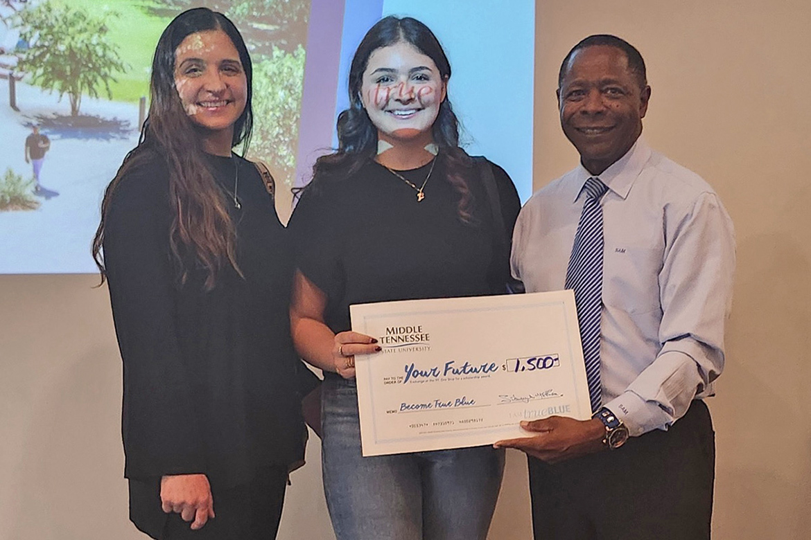 South Gibson High School senior Fatima Razeq, center, was among several lucky students who received scholarships totaling $10,900 from Middle Tennessee State University President Sidney A. McPhee, right, after he drew names to conclude the evening student reception as part of the Murfreesboro, Tenn., university’s True Blue Tour stop on Nov. 5 at the Jackson Country Club in Jackson, Tenn. (MTSU photo by Jimmy Hart)