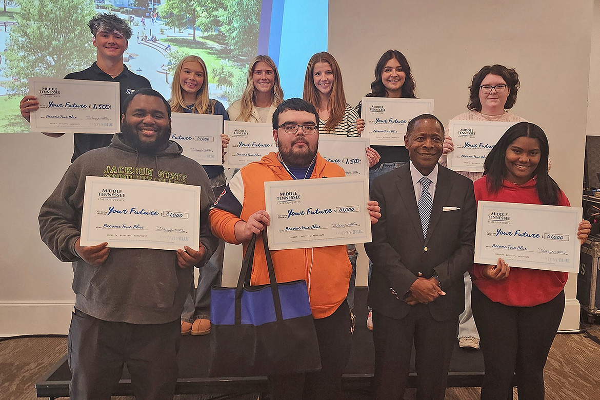 Middle Tennessee State University President Sidney A. McPhee, front row, second from right, is shown with several lucky high school students who received scholarships totaling $10,900 at the evening student reception during the Murfreesboro, Tenn., university’s True Blue Tour stop on Nov. 5 at the Jackson Country Club in Jackson, Tenn. (MTSU photo by Jimmy Hart)