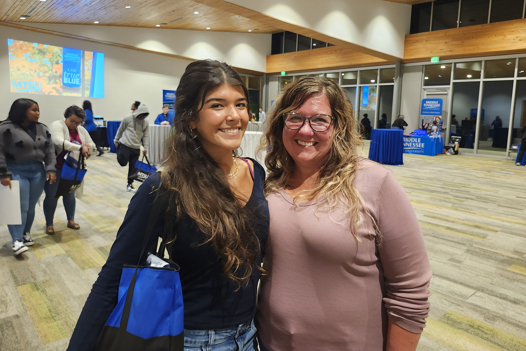 Already admitted to Middle Tennessee State University to pursue its pro-pilot degree, Lauren Perez, left, a senior at White State High School in Memphis, Tenn., and her mother, Samantha, attend the Murfreesboro university’s True Blue Tour stop on Nov. 4 at the FedEx Event Center at Shelby Farms in Memphis. (MTSU photo by Jimmy Hart)