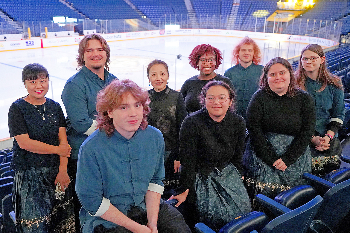 Members of the Chinese Music Ensemble at Middle Tennessee State University in Murfreesboro, Tenn., pose for a photo next to the ice in Bridgestone Arena in Nashville, Tenn., before their performance at the Nashville Predators game on Dec. 9 as part of Asian and Pacific Islander music heritage night. Pictured, front row, from left, are volunteer Bo Capistrant, student Ani Heng, student Kylei Loh, and student William Sprayberry; and back row, from left, Chinese scholar Jingyi Zhan, student Henry Wright, Chinese Music and Culture Center Director Mei Han, student Jaida Anthony, and volunteer Jake Capistrant. (MTSU photo by Mike Davis)