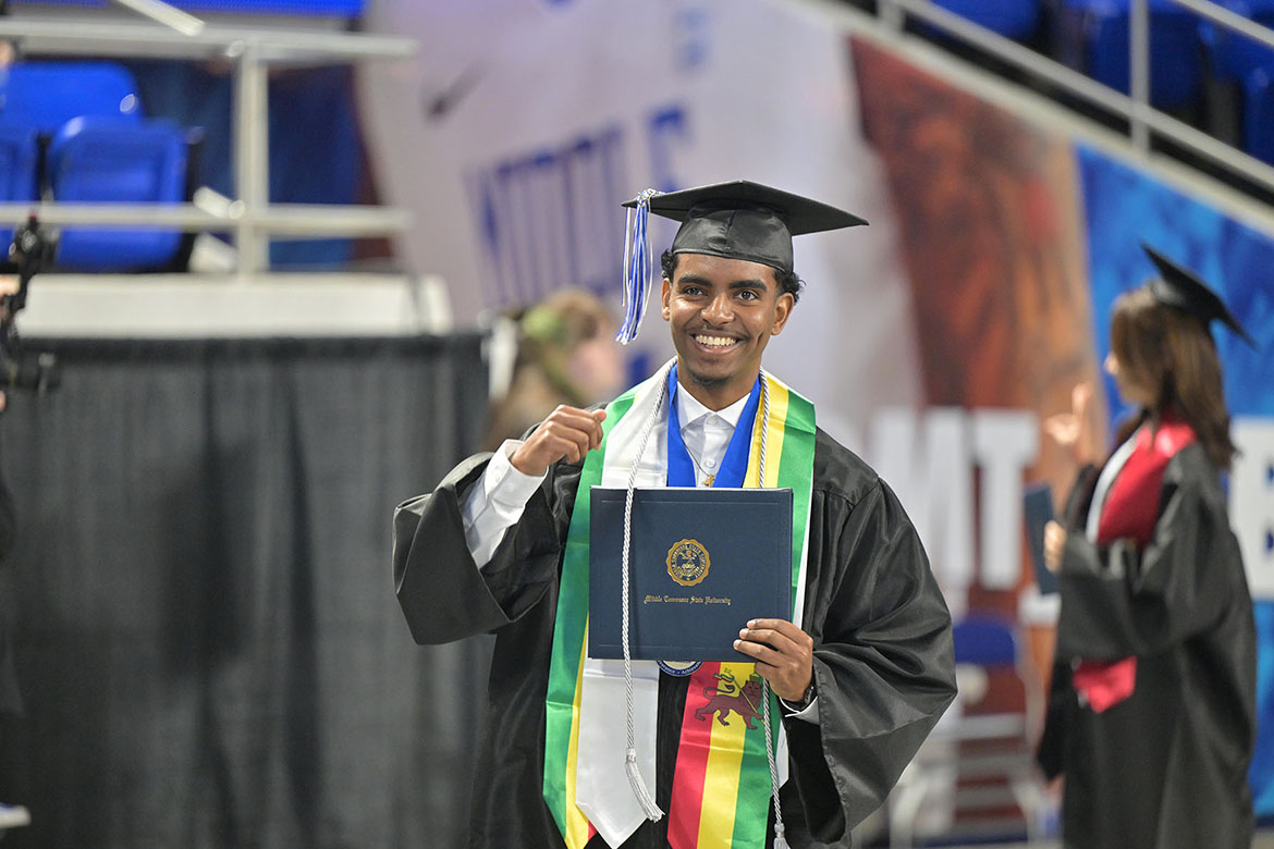 A Middle Tennessee State University graduate waves to a supporter after receiving his degree alongside more than 1,600 new Blue Raider alumni during the fall 2025 morning commencement ceremony held Saturday, Dec. 13, inside Murphy Center on campus in Murfreesboro, Tenn. (MTSU photo by James Cessna)