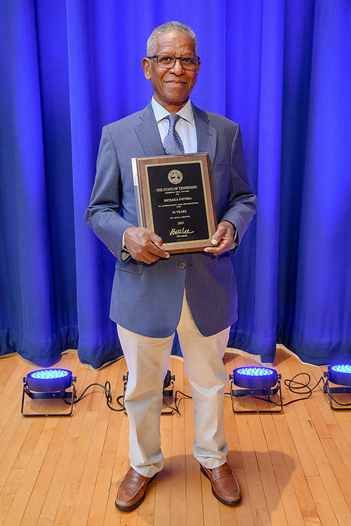 Middle Tennessee State University recently retired economics and finance professor Bichaka Fayissa holds his award as the longest-tenured MTSU employee honored with 45 years of service during the annual Service Awards Luncheon held in early December in the James Union Building Ballroom on campus in Murfreesboro, Tenn. (MTSU photos by Andy Heidt)