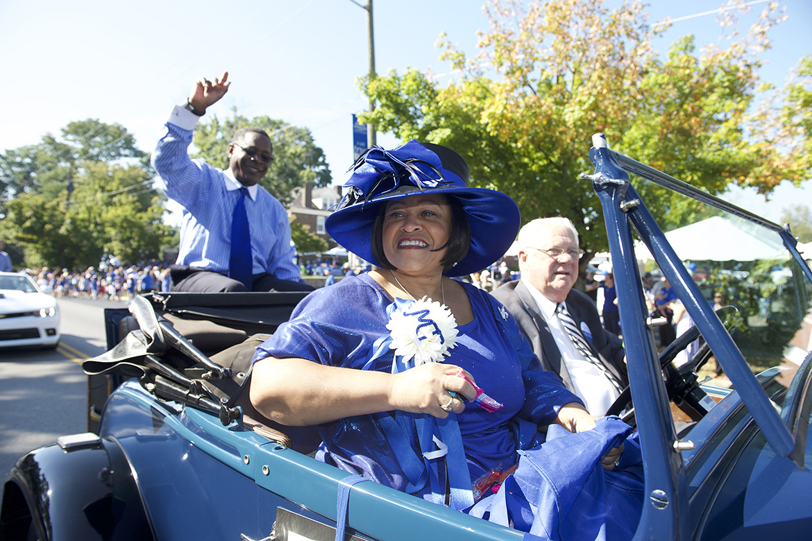 In this 2013 file photo, Middle Tennessee State University First Lady Elizabeth McPhee, center, wearing one of her signature hats, is all smiles at the Homecoming Parade. (MTSU file photo by J. Intintoli)
