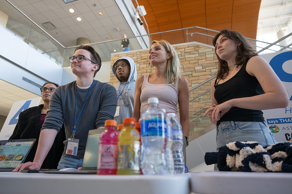 Classmates and members of Team Sababu Bites, from left, Gabby Vadai, Garrett Johnson, Darius Baisden, Heather Holt and Karigan Stewart, listen to commentary about a mobile app they created for the 11th annual Middle Tennessee State University Computer Science Department HackMT, a 36-hour hackathon competition held on campus Friday, Jan. 30, through Sunday, Feb. 1 in Murfreesboro, Tenn. (MTSU photo by Cat Curtis Murphy)