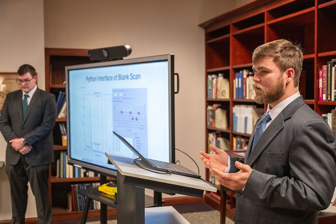 Brantley Harriman, right, talks during the presentation in Special Collections at James E. Walker Library at Middle Tennessee State University in Murfreesboro, Tenn., for the “Poisoned Pages” project he co-led with Ethan Coyle, at left, and Brittney Cupp during the 2025 fall semester. In partnership with Special Collections, the team of students, along with their Department of Chemistry instructors Jessie Weatherly and Sarah Pierce, tested dozens of Victorian-era books for pigments containing toxic compounds and heavy metals. (MTSU photo by Cat Curtis Murphy)