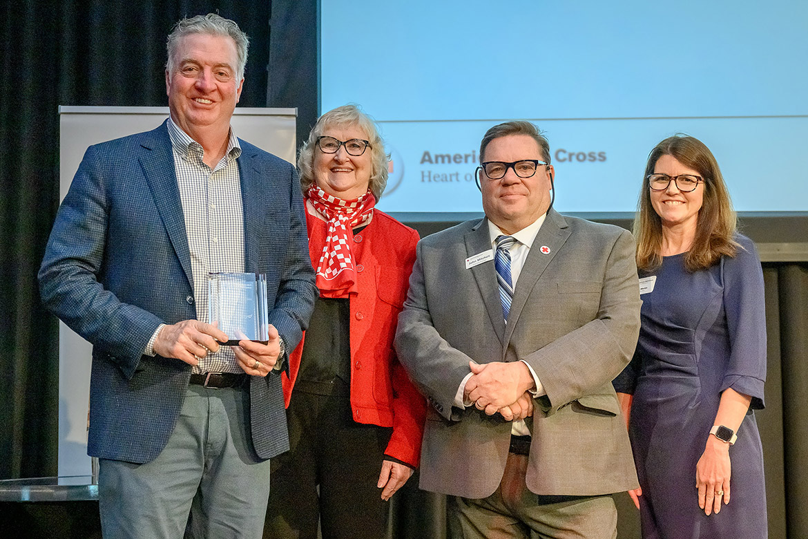 Middle Tennessee State University Board of Trustees member John Floyd, far left, holds the Heroes Award presented to him by American Red Cross Heart of Tennessee Chapter Board Chair Ginny Williams, second from left, Executive Director John Mitchell, second from right, and board member Christy Martin during the nonprofit’s annual Heroes Luncheon held Thursday, March 12, at the Student Union Ballroom on campus in Murfreesboro, Tenn. (MTSU photo by J. Intintoli)