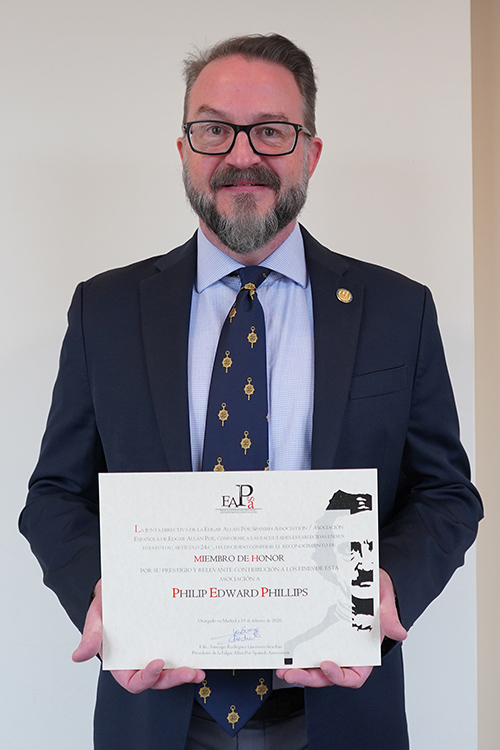 Philip Phillips, associate dean and professor of English in the University Honors College at Middle Tennessee State University in Murfreesboro, Tenn., holds the certificate for the Miembro de Honor award he received from the Asociación Española Edgar Allan Poe during its fourth international Edgar Allan Poe Spanish Association Conference held in February at the Universidad Autónoma de Madrid in Spain. (MTSU photo by Robin E. Lee)