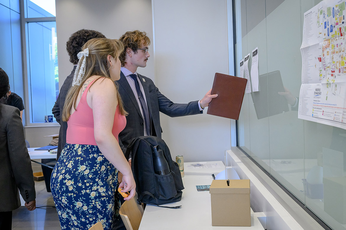 Competitors in the International Public Debate Team National Championships and Convention, hosted April 10-13 by Middle Tennessee State University on campus in Murfreesboro, Tenn., check out assignments in the Academic Classroom Building on campus. MTSU’s Blue Raider Debate Team hosted 54 colleges and over 400 students for the four-day debate competition. (MTSU photo by J. Intintoli)
