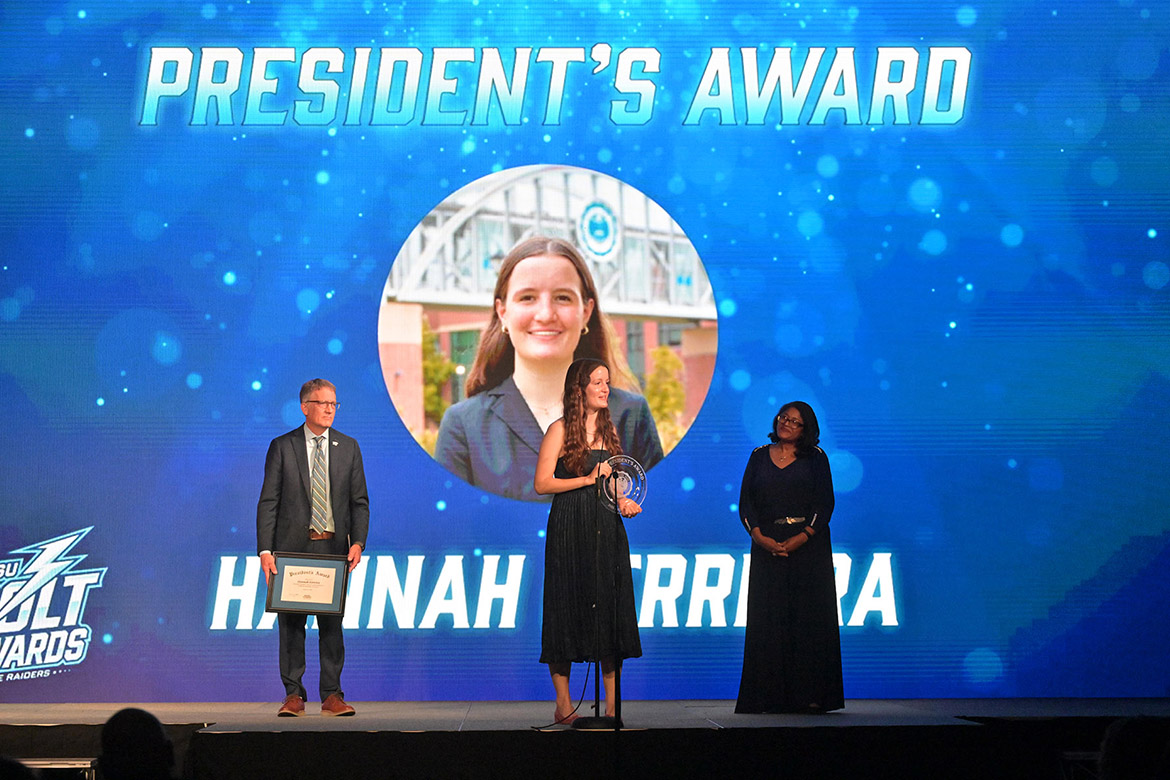 Hannah Ferreira, center, who is double majoring in political science and psychology at Middle Tennessee State University Student in Murfreesboro, Tenn., holds the MTSU President’s Award she was given during the MTSU Bolt Awards ceremony held Tuesday, April 14, in the Student Union Ballroom on campus in Murfreesboro, Tenn. Standing behind her on stage is MTSU Provost Mark Byrnes, at left, and College of Liberal Arts Dean Leah Tolbert Lyons, at right. (MTSU photo by James Cessna)