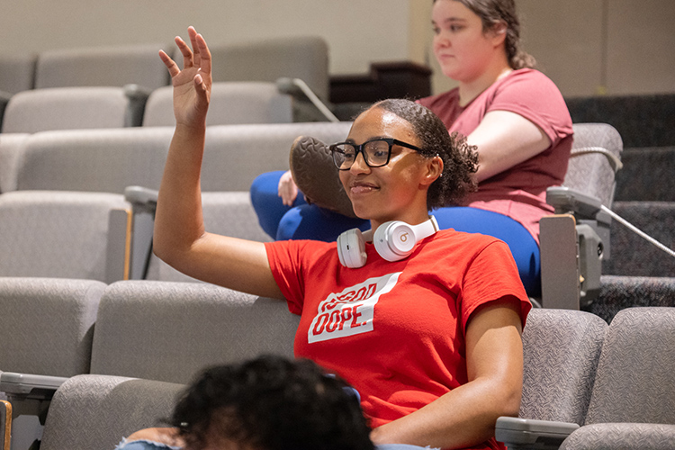 A Middle Tennessee State University student raises her hand to answer a question from Colin Ryan, keynote speaker for Middle Tennessee State University’s Tennessee Financial Literacy Month, during his presentation April 15 at the Business and Aerospace Building’s State Farm Room on campus in Murfreesboro, Tenn. (MTSU photo by James Cessna)