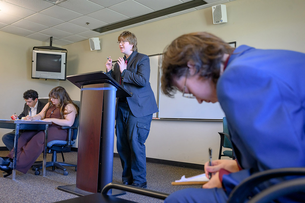 Middle Tennessee State University Blue Raider Debate Team member Sage Robinson, standing, and Liam Boardwine, team president, seated at right, compete in a Team-International Public Debate Association round against Mississippi State University’s Sam Harvey and Kamron Hitson during the International Public Debate Association Championships held on campus in Murfreesboro, Tenn. (MTSU photo by J. Intintoli)