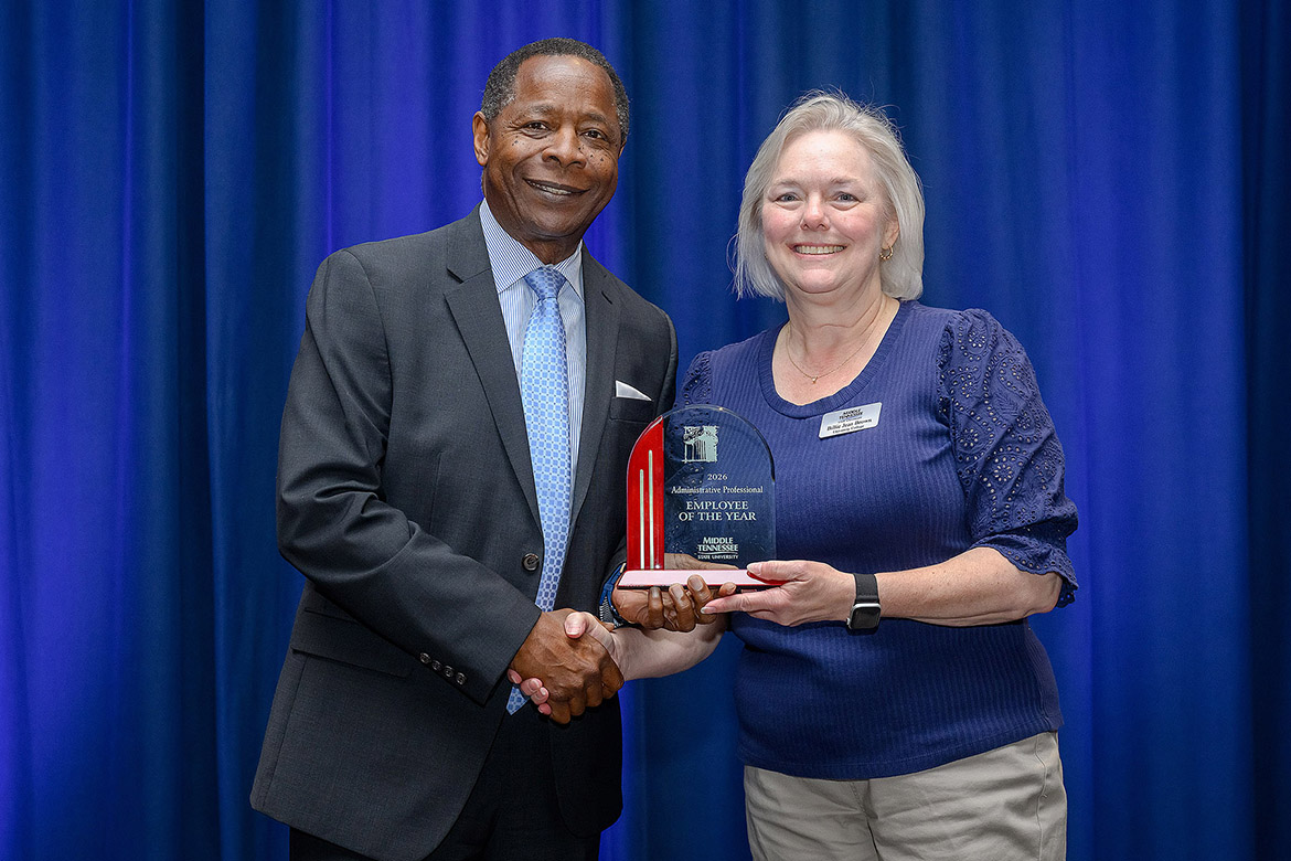 Middle Tennessee State University President Sidney A. McPhee, left, presents the 2025-26 Administrative Professional Employee of the Year Award to University College senior administrative associate Billie Jean Brown at the annual Employee Recognition Awards held Wednesday, April 22, in the James Union Building on campus in Murfreesboro, Tenn. (MTSU photo by Andy Heidt)